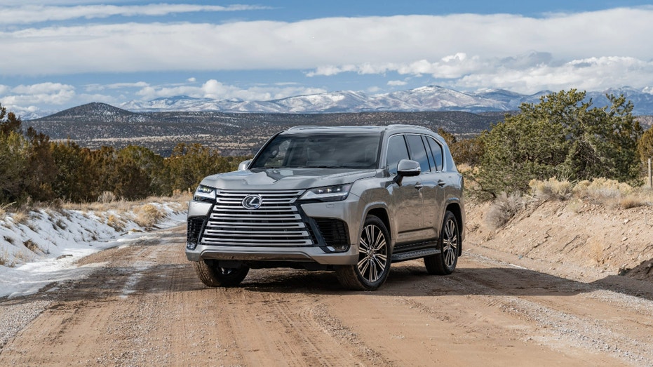 A Lexus LX SUV on a dirt road.