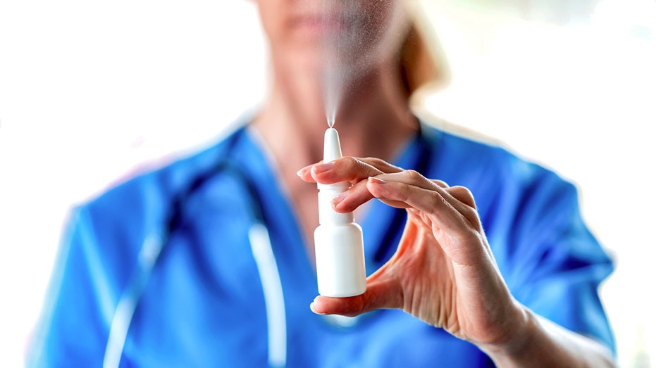 Doctor holding nasal spray