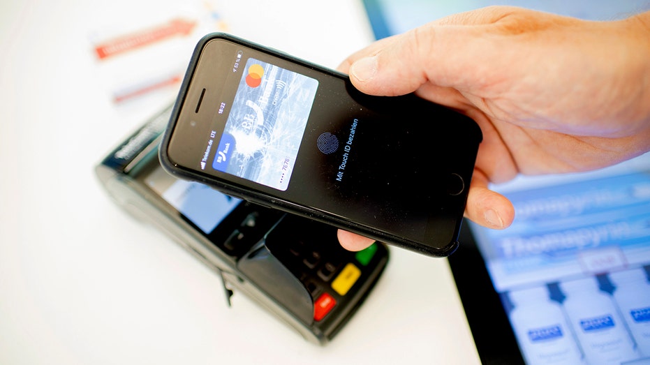 A man pays with touch ID off his cellphone.