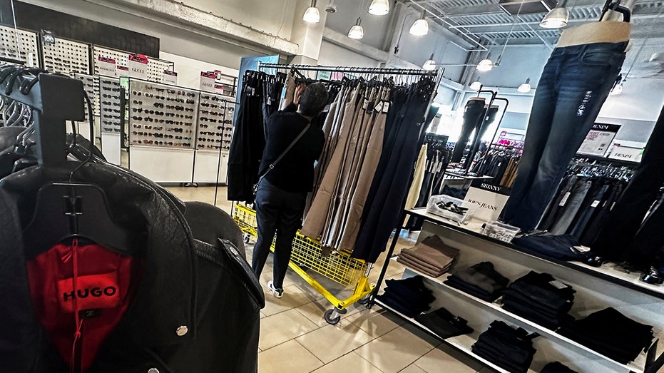 A woman shops inside a Saks OFF 5TH department store in Westbury, New York