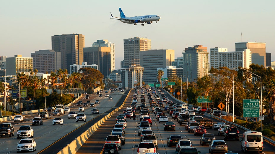 US highway with car traffic and plane in air