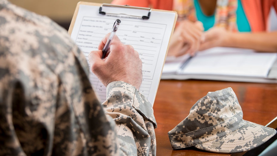 US military personnel filling out paper form