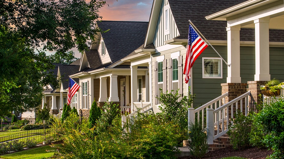 Homes in suburban neighborhood with American flags