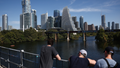 A view of the downtown buildings and the Lady Bird Like as people are seen on the Pfluger Pedestrian Bridge in Austin, United States on October 20, 2025. - Fox News
