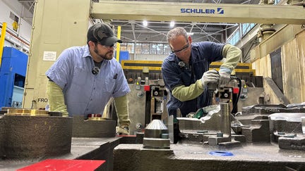 Michael Trevorrow, GM's senior vice president of global manufacturing, is sanding or adjusting part of a metal mold (a die) so it fits exactly with the matching top piece. He&rsquo;s making sure both parts line up correctly before the factory begins using it in production. - Fox Business News