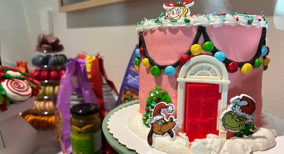 A cake with pink frosting and a red door.