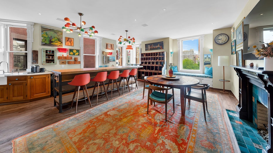 The kitchen features a large dining island, and is connected to the dining room. The room also contains a fireplace.