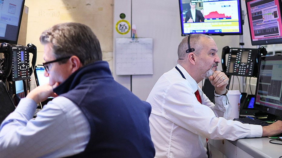 Traders work on the floor of the New York Stock Exchange during morning trading on April 30, 2025 in New York.