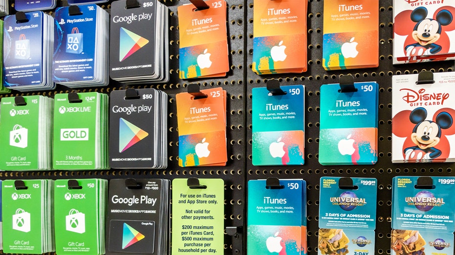 A retail display showcases various gift card options inside a supermarket.