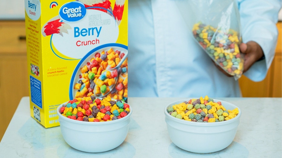 A food scientist holds a bag of multicolored cereal.