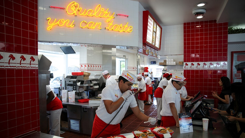 Workers serve customers at In-N-Out Burger outlet in Los Angeles