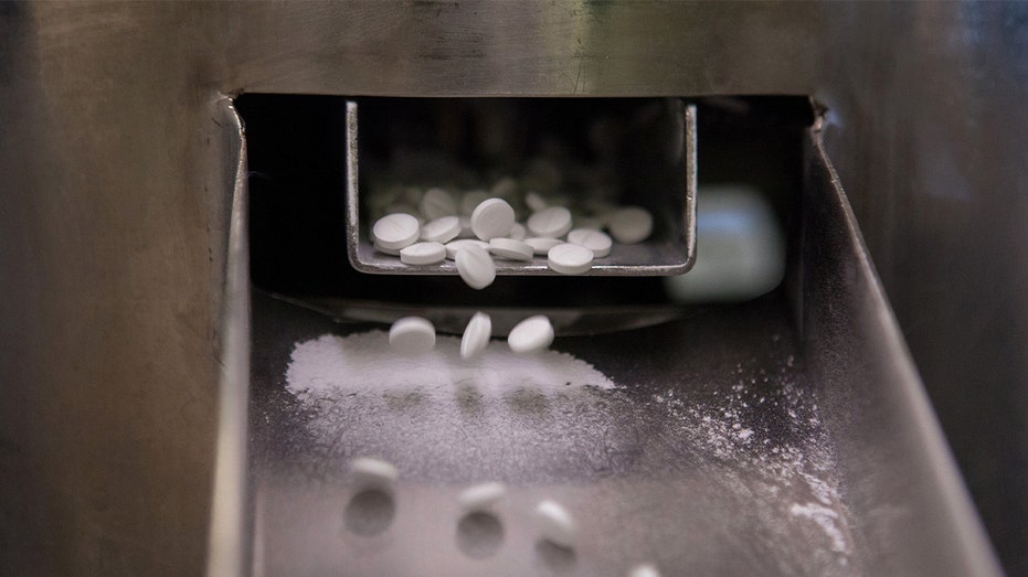 white pills come out manufacturing line