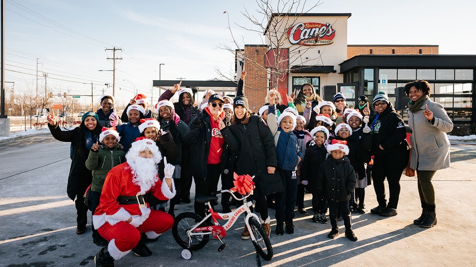 Children and volunteers at Raising Cane's holiday giveaway