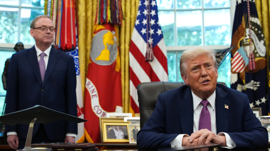 Director of the National Economic Council Kevin Hassett looks on as U.S. President Donald Trump speaks to reporters in the Oval Office of the White House.