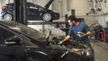 A mechanic works on a Ford Motor Co. car at the Northstar Ford dealership in Fort McMurray, Alberta, Canada, on Thursday, June 13, 2019. - Fox News