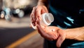 Close up of human hands. Man holding the medicine bottle in one hand and pill in other - Fox News