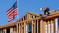 A worker affixes panels to the roof of a new KB Home unit in Phoenix, Arizona. - Fox News