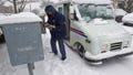 A US Postal Service carrier delivers mail during a snow storm March 5, 2015 in Manassas, Virginia. A major winter storm slammed parts of the United States Thursday, as thousands of flights were canceled and government offices shut down in anticipation of more than half a foot of snow in Washington, D.C. - Fox News