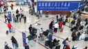 People walk around the airport