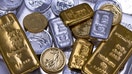 A selection of gold and silver bars and one-ounce gold and silver coins arranged at Gold Investments Ltd. bullion dealers in London, UK. - Fox Business News