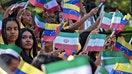 Young women wave national flags of Venezuela and Iran during the arrival of  former Iranian President Ebrahim Raisi at Miraflores Presidential Palace in Caracas, on June 12, 2023. - Fox Business News