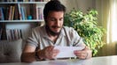 A man smiles after receiving his tax return. - Fox Business News