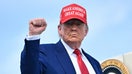 President Donald Trump pumps his fist as he boards Air Force One at Morristown Municipal Airport in Morristown, New Jersey, on June 21, 2025 as he returns to the White House from his golf club in Bedminster, New Jersey.  - Fox Business News
