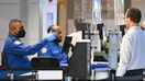 TSA agents check passenger identity documents at a security checkpoint security at Reagan National Airport on the first day of the US government shut down in Arlington, Va., on Oct.1, 2025 - Fox Business News
