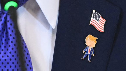 A detail of US President Donald Trump's lapel pins are seen during a meeting with US oil companies executives in the East Room of the White House in Washington, D.C. on Jan. 9, 2026.  - Fox Business News
