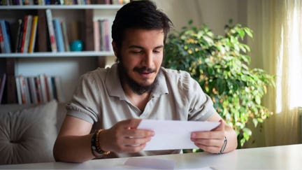 A man smiles after receiving his tax return. - Fox Business News