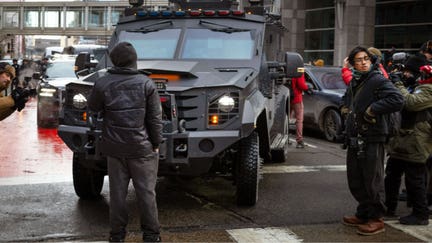 A demonstrator blocks a SWAT vehicle while protesting the Trump administration's push to round up and deport undocumented immigrants on January 17, 2026 in Minneapolis, Minnesota. - Fox Business News