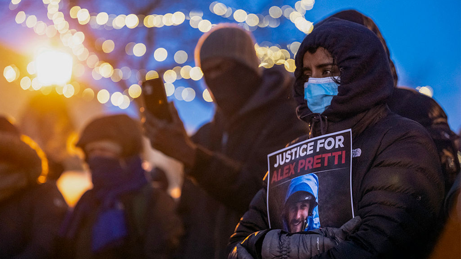 People mourn at a makeshift memorial in the area where 37-year-old Alex Pretti was shot dead by federal immigration agents
