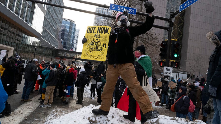 Anti-ICE protesters scuffle with an ICE supporter (L) who was in downtown to attend a "Americans Against Islamification" rally near City Hall in Minneapolis,