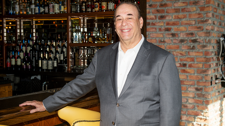 Jon Taffer standing in front of a bar