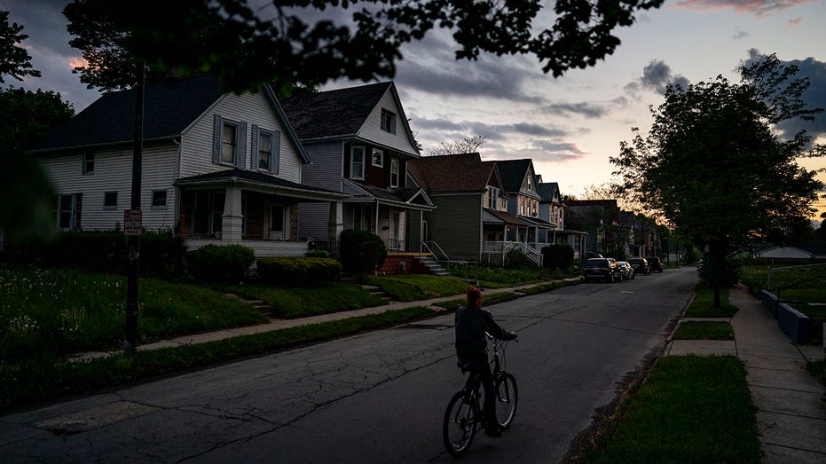 A person rides a bike along Laurel Street in Buffalo.