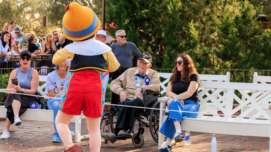 Herb Maneloveg and his family during a parade at Disney World
