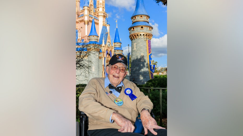 Herb Maneloveg sitting in front of the castle at Disney World
