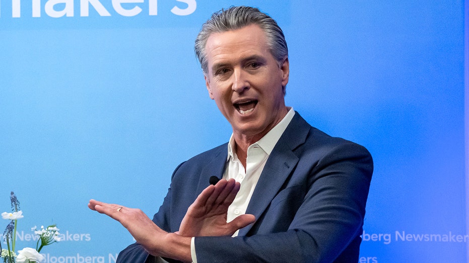 Gavin Newsom folds his hands to make the gesture