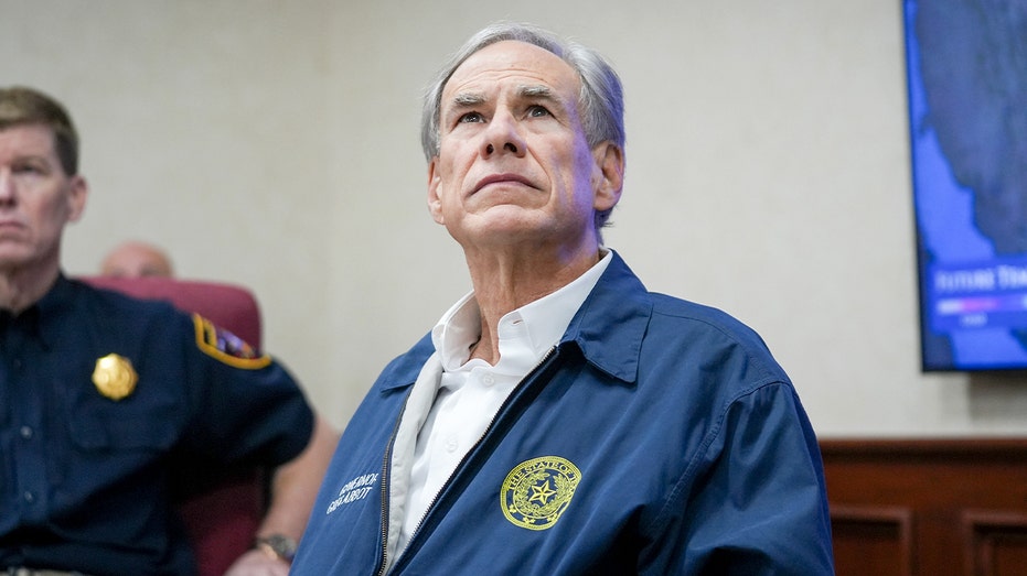 Texas governor inside an emergency operations center as officials review information.