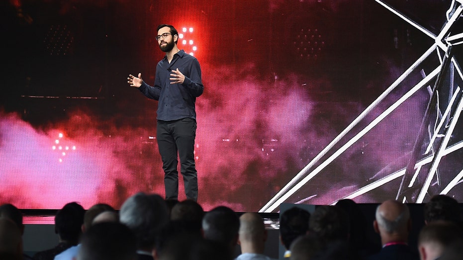 spotify's charlie hellman in dark clothing speaking onstage