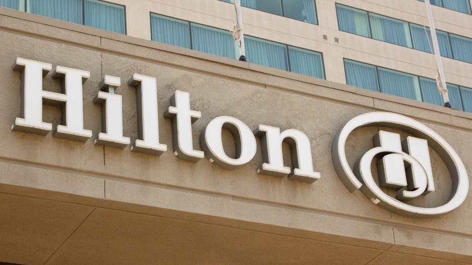 Hilton hotel exterior with the company’s logo displayed on the building.