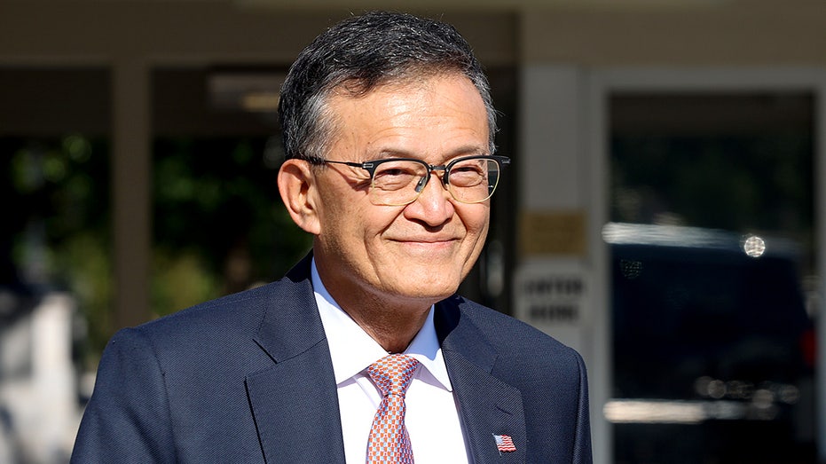 Intel CEO Lip-Bu Tan walks away from the White House following a meeting.