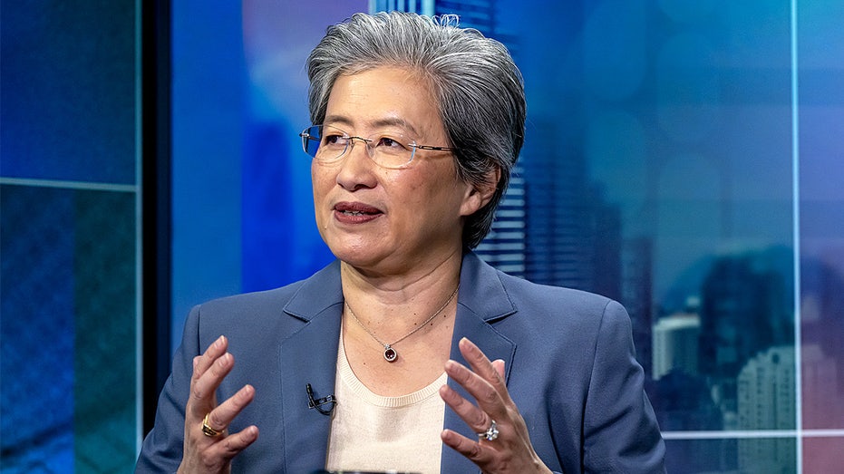 AMD CEO Lisa Su speaks during a television interview while seated in a studio setting.