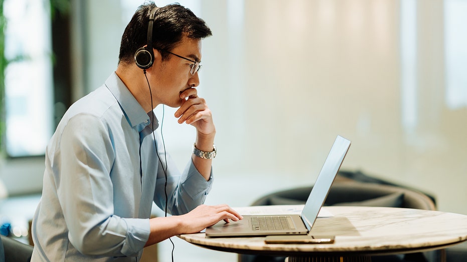 Businessman in modern office with headphones.