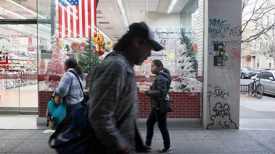 A man walks in front of a store in New York.