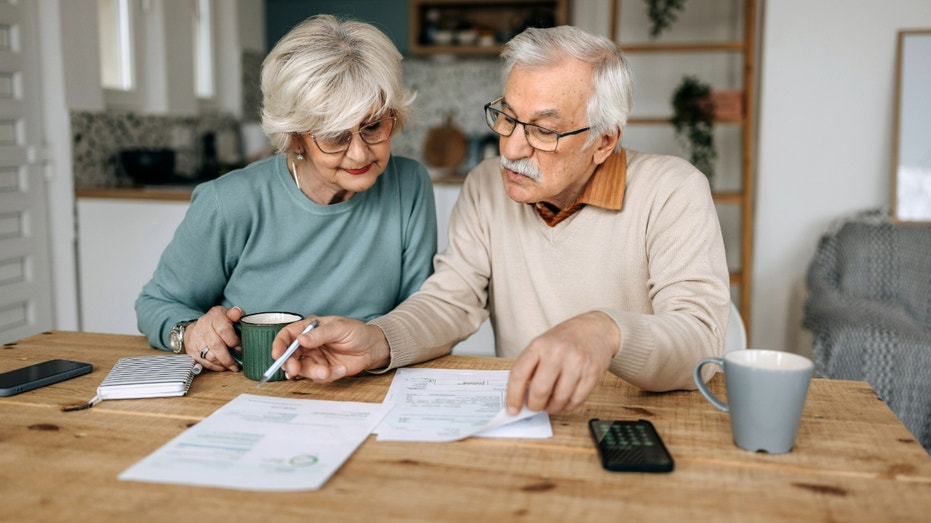 Older man and woman looking at tax forms.