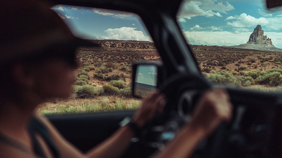 A person driving on a highway in Arizona.