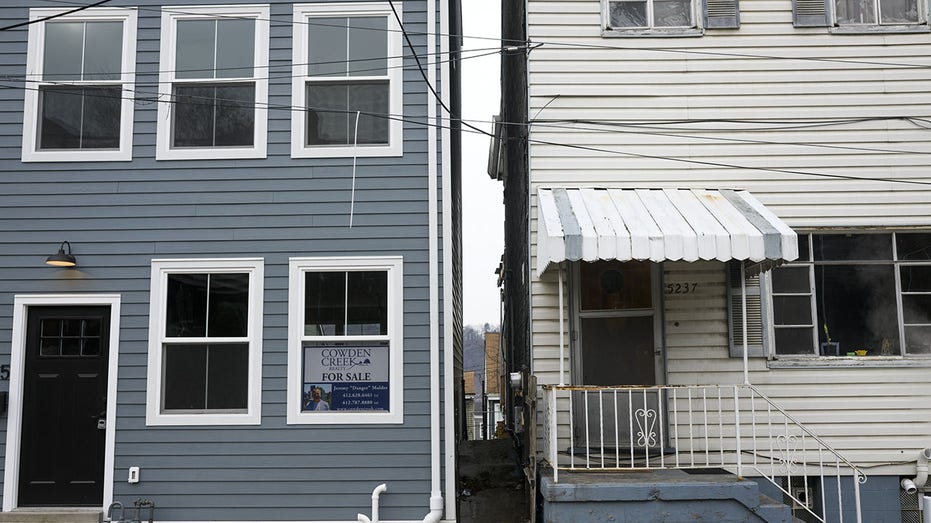 A "For Sale" sign is displayed in the Lawrenceville neighborhood of Pittsburgh, Pennsylvania,