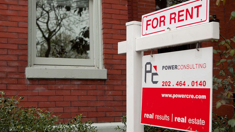 A POWERConsulting & Real Estate for rent sign stands in front of a row house in the Logan Circle neighborhood of Washington, D.C.