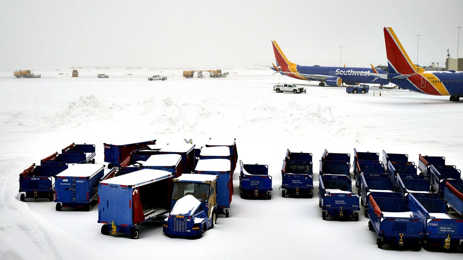 snow covers Southwest Airlines planes at Ronald Reagan Washington National Airport 